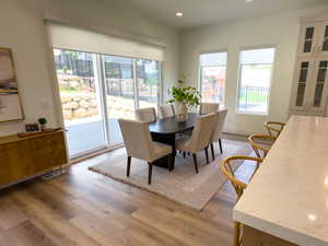 Dining room with plenty of natural light, light wood-style flooring, and recessed lighting