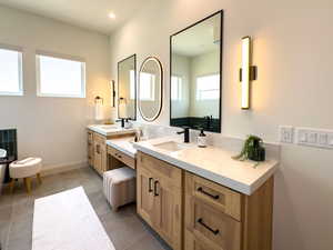 Full bath featuring vanity, baseboards, and tile patterned floors