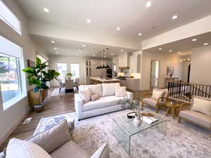 Living area with recessed lighting, light wood finished floors, and baseboards