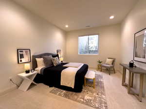 Bedroom with light carpet, recessed lighting, and baseboards
