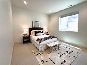 Carpeted bedroom with baseboards and recessed lighting