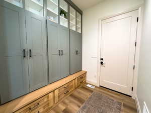 Mudroom featuring light wood-type flooring and baseboards