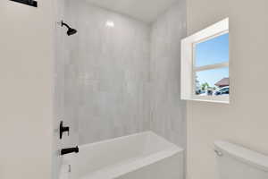 Full bath with toilet and shower / tub combination