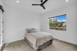 Carpeted bedroom with recessed lighting, baseboards, and ceiling fan