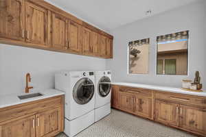 Laundry area with separate washer and dryer and cabinet space