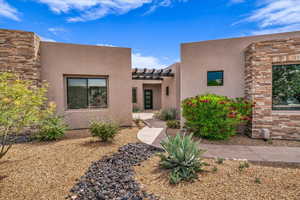 View of front facade with stucco siding and stone siding