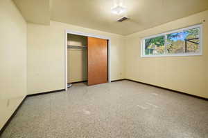 Unfurnished bedroom featuring baseboards and a closet