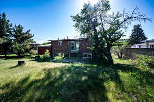 Rear view of property featuring brick siding