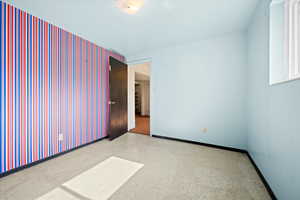 Empty room with tile patterned floors and baseboards