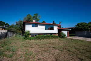 Rear view of house with an attached garage