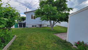 View of grassy yard with cooling unit