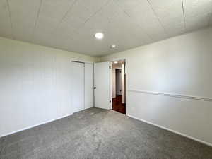 Unfurnished bedroom featuring carpet and a closet