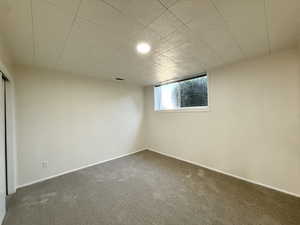 Basement featuring carpet and baseboards