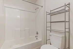 Bathroom with toilet and shower / bath combination
