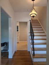 Staircase featuring wood finished floors
