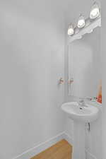 Bathroom featuring baseboards and wood finished floors