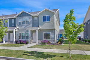 View of front facade featuring a front yard and board and batten siding