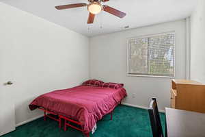 Carpeted bedroom with baseboards and ceiling fan