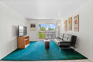 Carpeted living area with baseboards