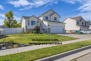 View of front of house with concrete driveway and an attached garage