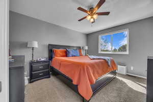Bedroom with carpet, baseboards, and ceiling fan