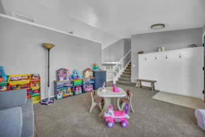 Playroom with carpet and lofted ceiling
