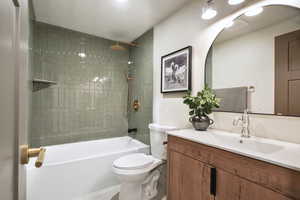 Full bath with shower / bathtub combination, toilet, and vanity