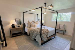 Bedroom with baseboards, a textured ceiling, and ceiling fan