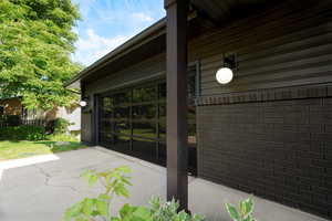 View of patio with concrete driveway
