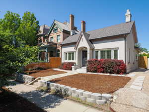 View of front of home featuring a shingled roof and stucco siding