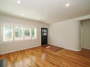 Foyer featuring light wood-style floors, baseboards, and recessed lighting