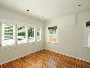 Unfurnished room featuring baseboards, light wood-style floors, and recessed lighting