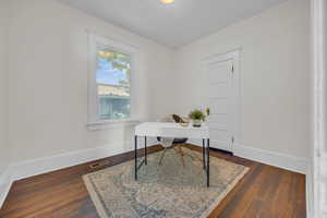 Home office featuring baseboards and wood finished floors