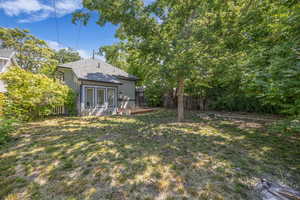 Back of house with roof with shingles and a deck