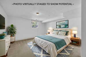 Bedroom featuring light colored carpet and baseboards