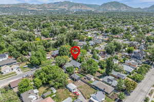 View of property location featuring mountains and nearby suburban area