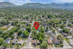 Aerial view of property's location with a mountainous background and nearby suburban area