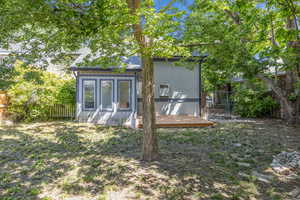 Back of house featuring roof with shingles