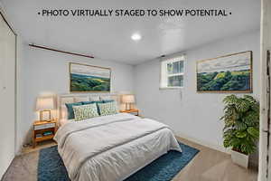 Bedroom featuring light colored carpet and baseboards