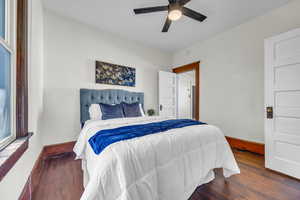Bedroom with wood finished floors, baseboards, and ceiling fan