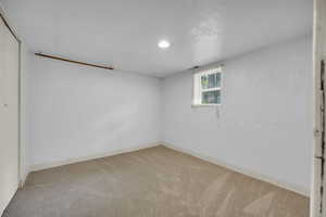 Basement featuring carpet floors and baseboards