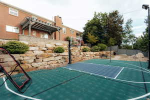 View of basketball court with a pergola and basketball court