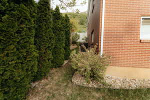View of property exterior with brick siding and cooling unit