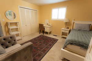 Bedroom with carpet floors, a closet, and baseboards