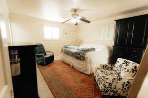 Bedroom featuring crown molding, baseboards, and ceiling fan