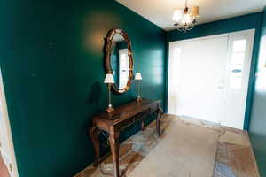 Entryway featuring a chandelier and healthy amount of natural light