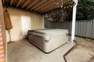 View of patio with a hot tub