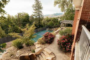 View of basketball court featuring a pergola and a mountain view