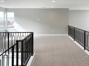 Corridor with carpet floors, an upstairs landing, recessed lighting, and baseboards