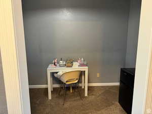 Carpeted home office with baseboards
